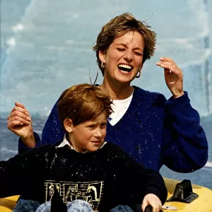 Princess Diana and Prince Harry laughing and getting soaked on water slide ride in Thorpe