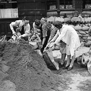 Shop workers in Birmingham city centre filling sandbags in preparation of the outbreak of