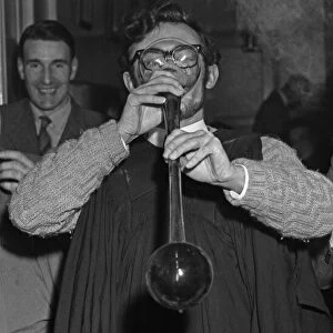 A student sinking a yard of ale at an unknown Cambridge pub. Circa May 1959