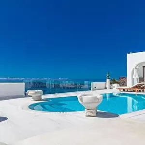 White architecture on Santorini island, Greece. Swimming pool in luxury hotel. Beautiful view on the sea, summer vacation, travel destination stunning