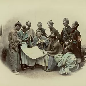 Portrait of a group of samurai and japanese officers in traditional clothes. They are intently consulting a map