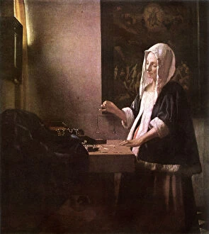Woman Weighing Gold by Jan Vermeer