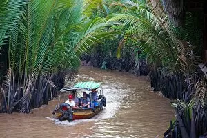 Tourist boat on canal on Con Lan (Unicorn) Island, near My Tho, Mekong Delta, Vietnam