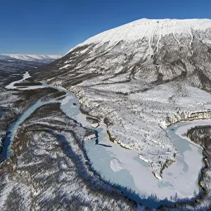 Frozen river and mountain in winter, Putorana Plateau, Siberia, Russia Frozen river and mountain in winter, Putorana Plateau, Siberia, Russia