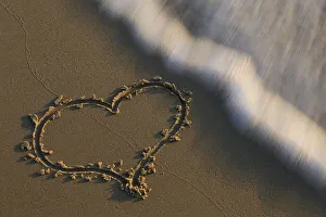 Heart in sand washed away by wave, The Netherlands, Noord-Holland Heart in sand washed away by wave, The Netherlands, Noord-Holland