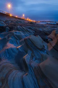 Dusk Prints: Light falling on the rocks on Berwick beach, Northumberland, England