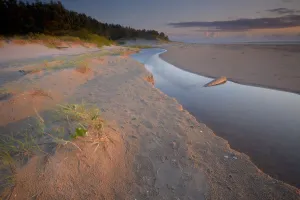 Little river flows over the beach in Slitere National Park, before ending in the Baltic Sea Little river flows over the beach in Slitere National Park, before ending in the Baltic Sea