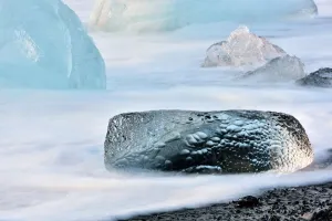 Long exposure image of crystal clear iceberg formations on the volcanic beach, Jokulsarlon, Iceland Long exposure image of crystal clear iceberg formations on the volcanic beach, Jokulsarlon, Iceland