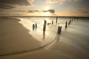 Sunset at the remains of an old plank way in the Baltic Sea near Mazirbe, Mazirbe